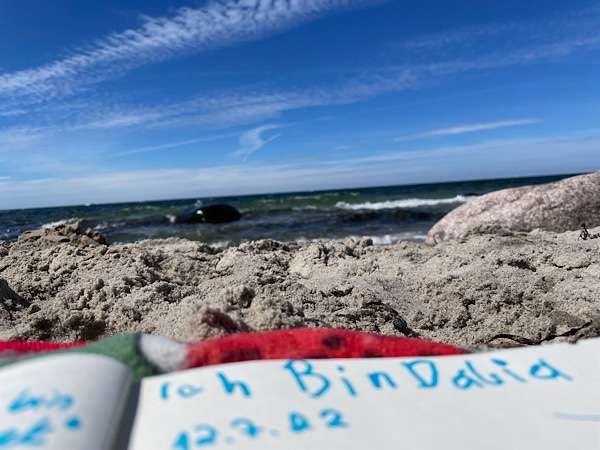 words written in a journal by a child, view of the sea