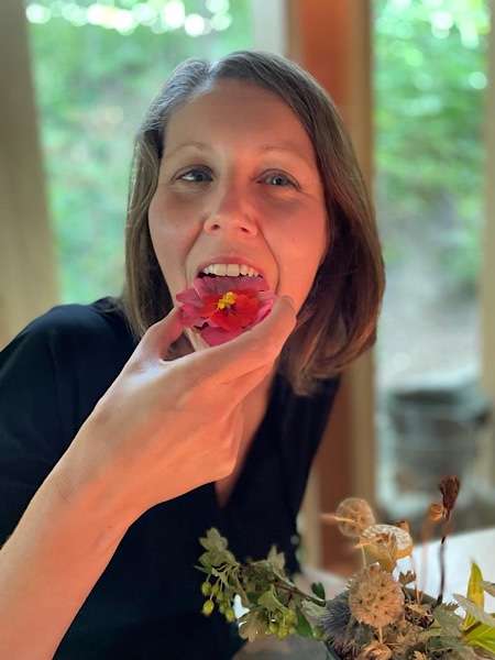 Woman biting into a flower at Noma restaurant