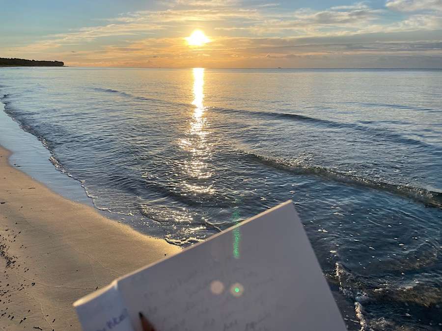 Notebook by the sea at sunrise