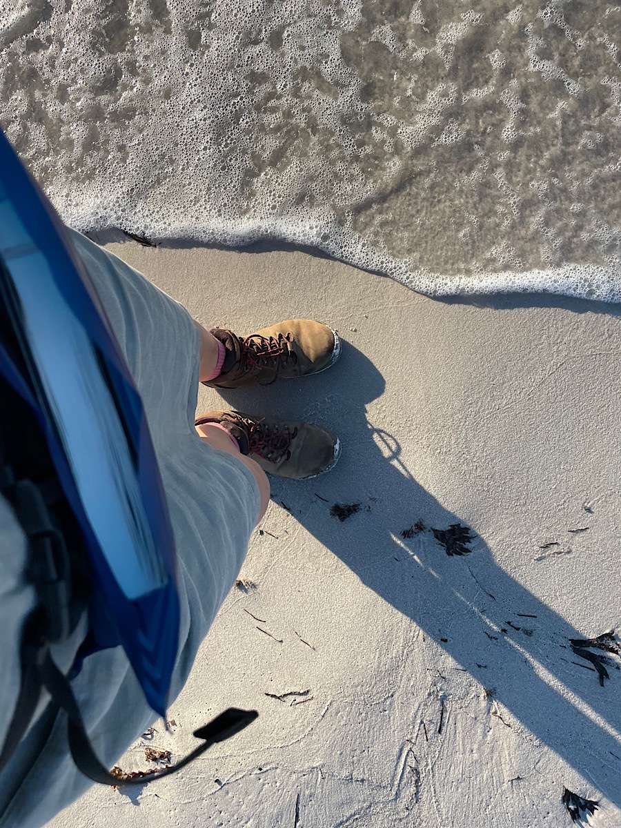 women's walking boots from above, and notebook for creative writing in a belt