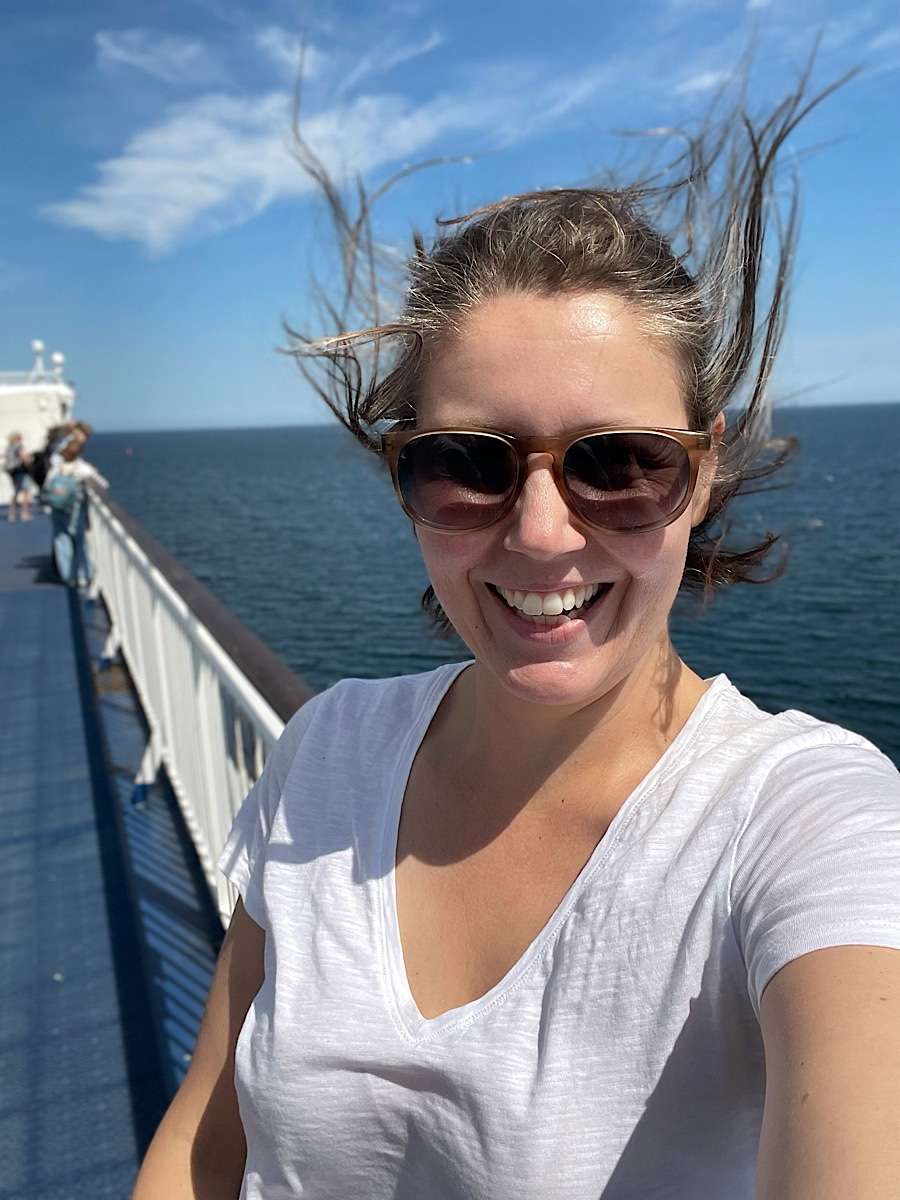 Woman standing in the wind on a ferry