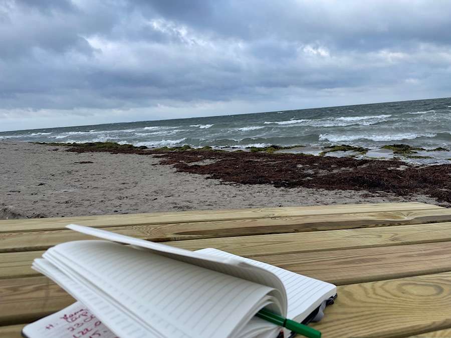 Notebook on a wooden table at the beach at the Baltic Sea